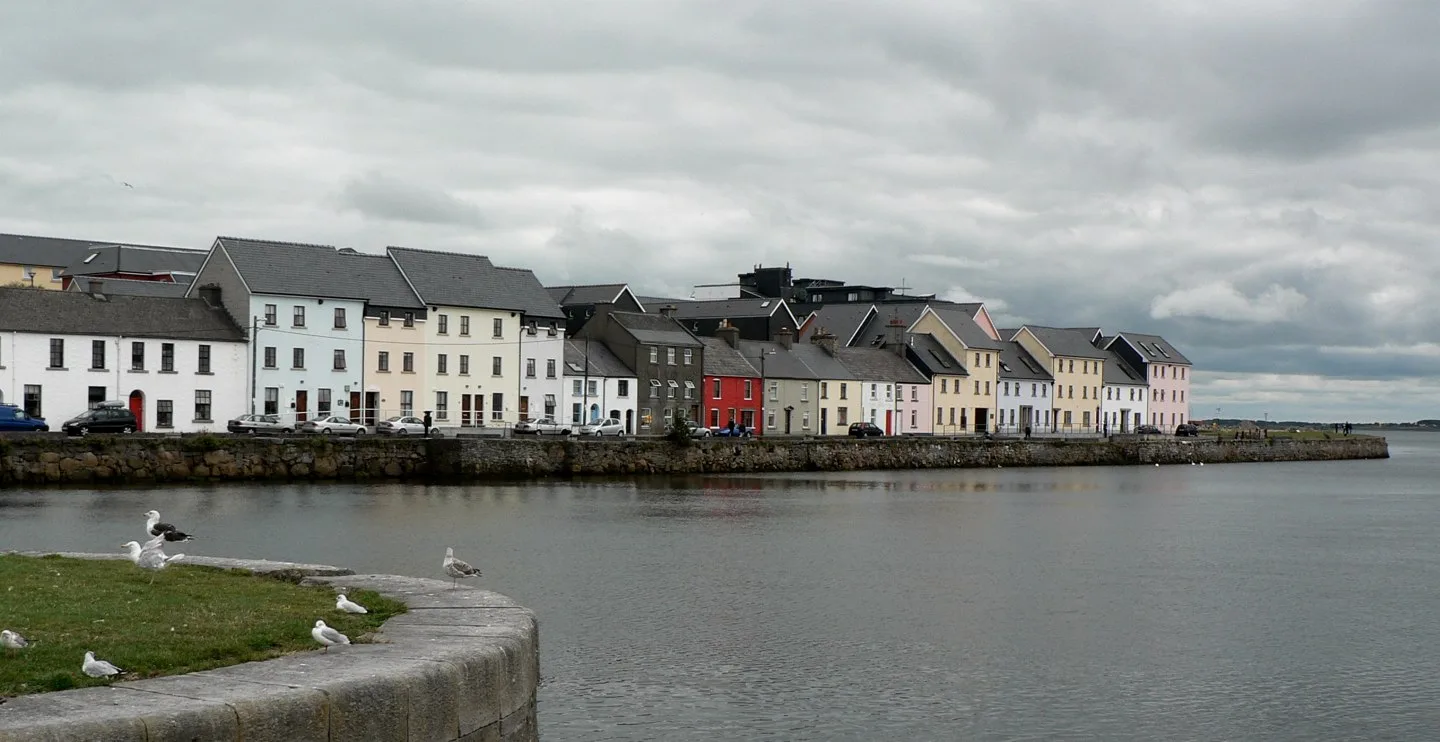 Pastel-coloured houses along the Long Walk waterfront in Galway.