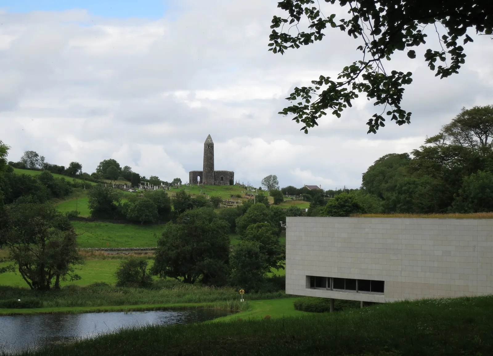 The Museum of Country Life in the grounds of Turlough Park, with the round tower in the distance.