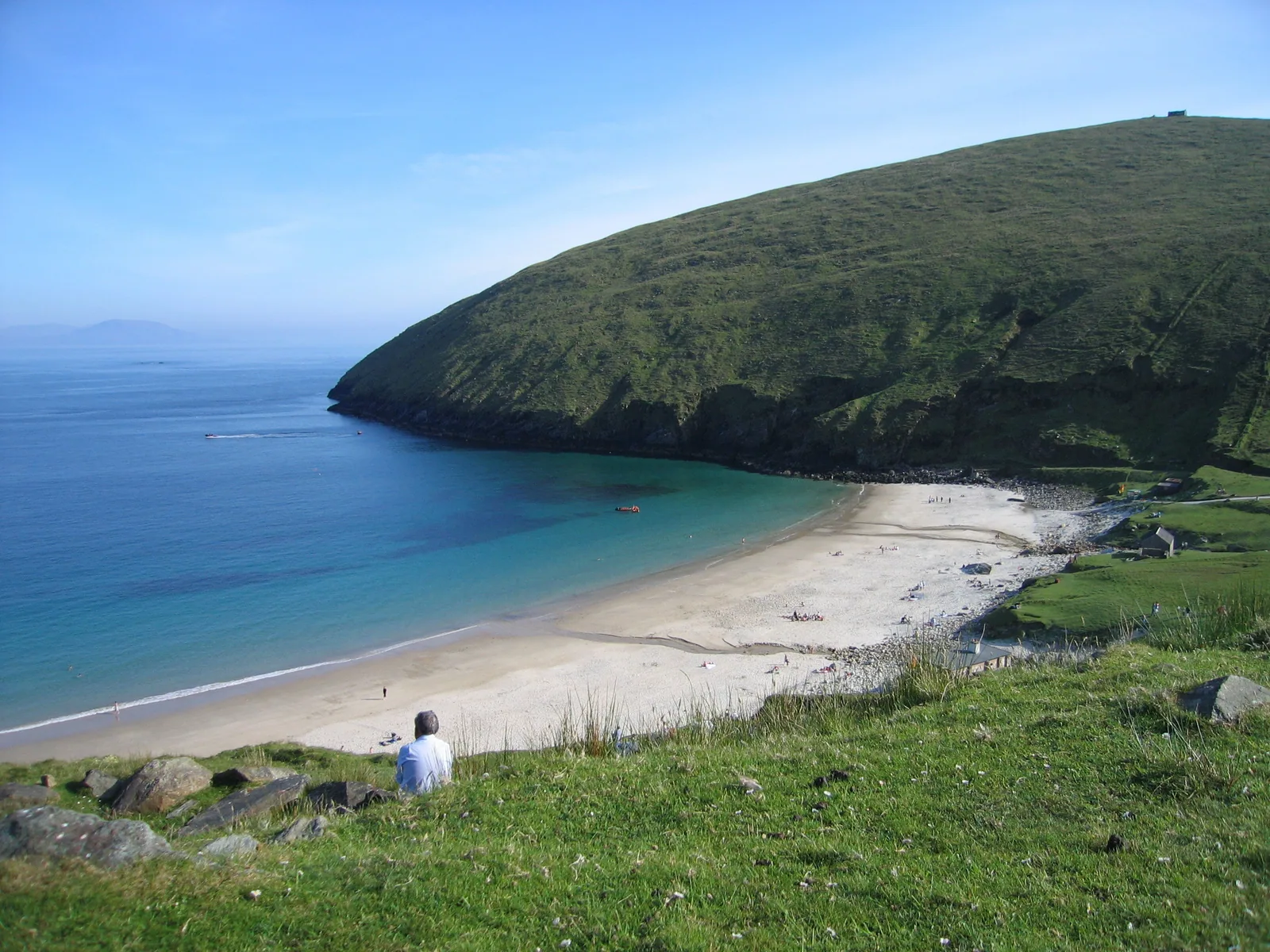 White sand and turquoise Atlantic water curve around Keem Bay beneath a green headland on Achill Island.