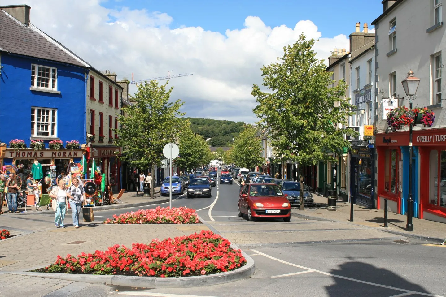 Colourful shops and flowers along Bridge Street in Westport.