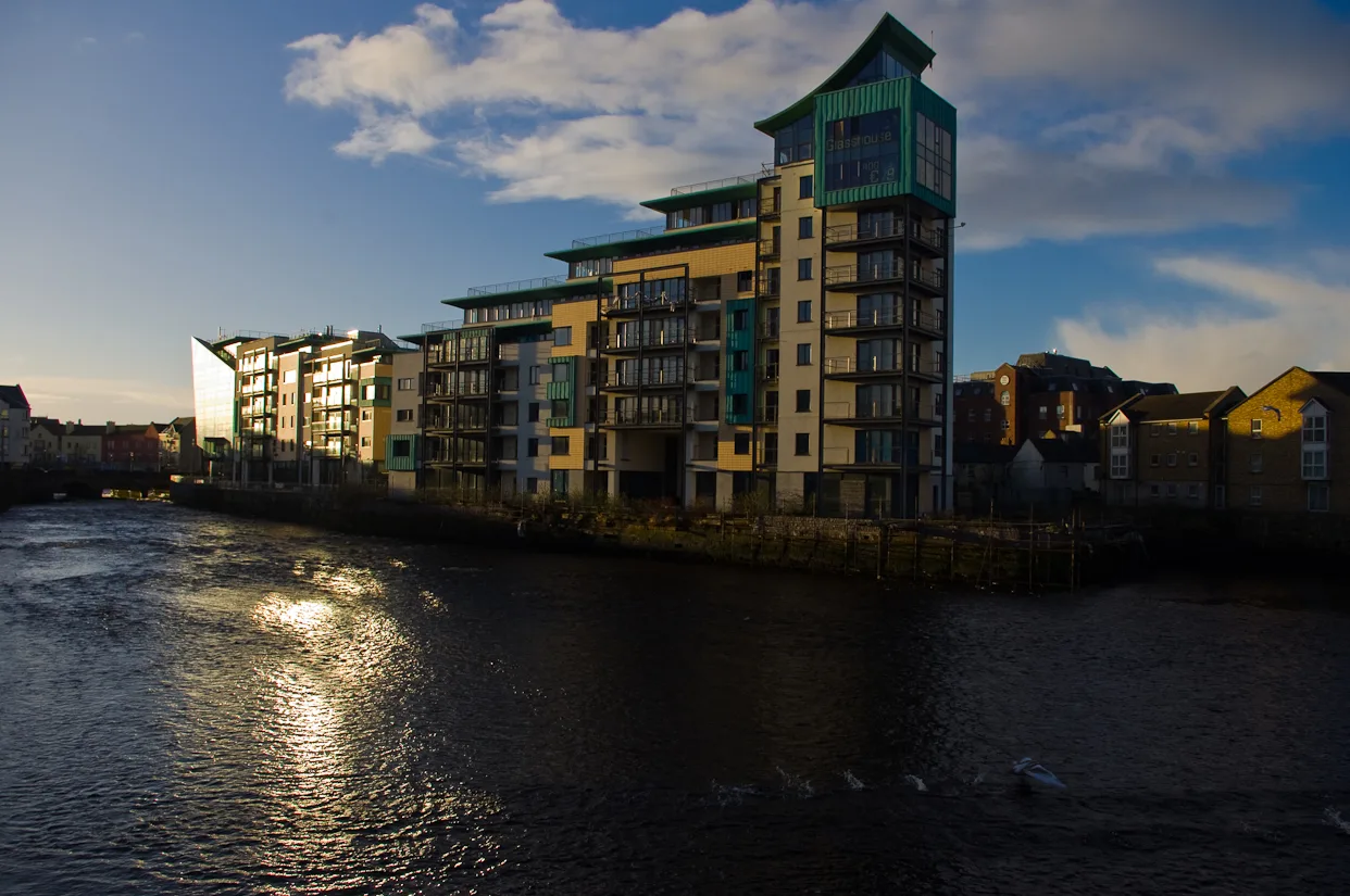 The Glasshouse hotel reflected in the Garavogue River at sunrise.